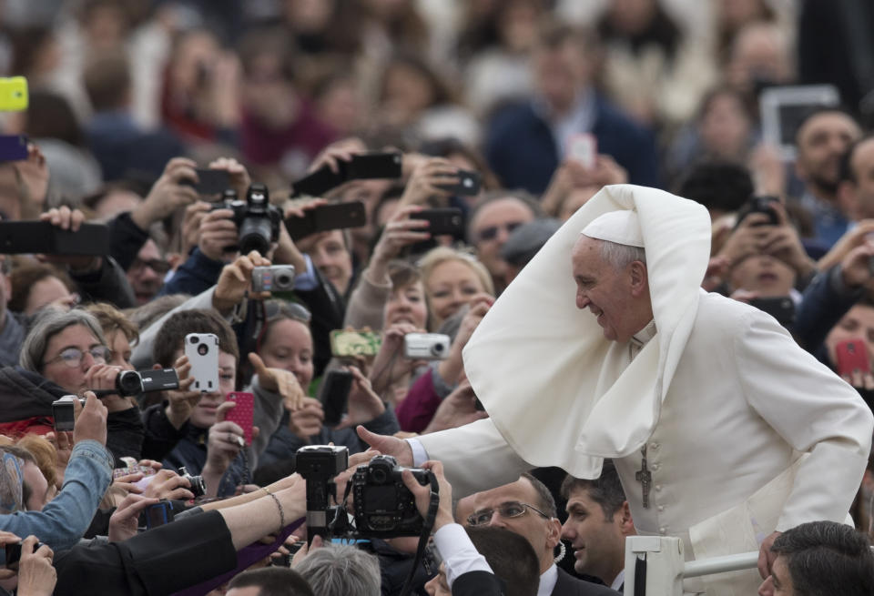Pope Francis is greeted by the faithful as he tours St. Peter's Square at the Vatican, prior to his general audience, Wednesday, Feb. 19, 2014. (AP Photo/Alessandra Tarantino)