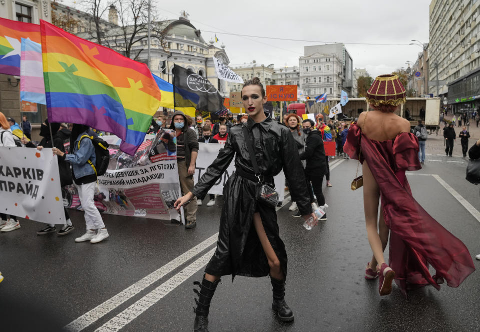 FILE - People take part in the annual Gay Pride parade, under the protection of riot police in Kyiv, Ukraine, Sunday, Sept. 19, 2021. Despite the war in Ukraine, the country's largest LGBT rights event, KyivPride, is going ahead on Saturday, June 25, 2022. But not on its native streets and not as a celebration of gay pride. It will instead join Warsaw's yearly Equality Parade, using it as a platform to keep international attention focused on the Ukrainian struggle for freedom. (AP Photo/Efrem Lukatsky, File)