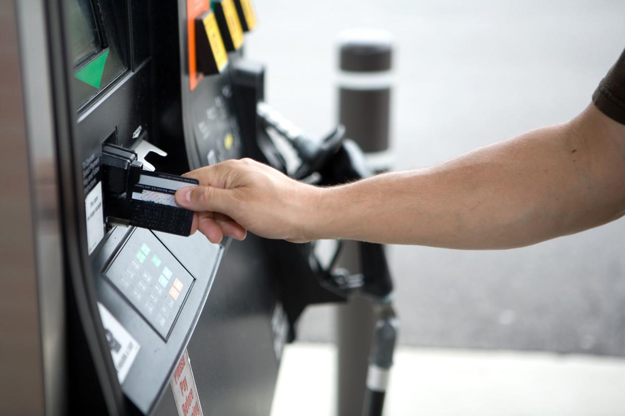 Man paying for gas with credit card.