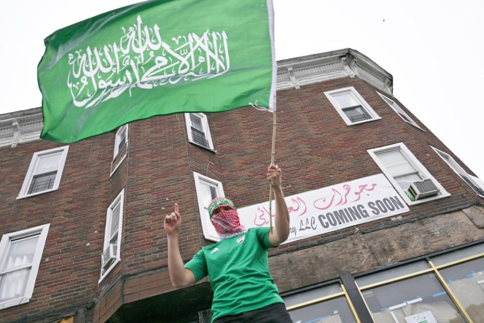 A pro-terror demonstrator waves a Hamas flag during a violent protest in Bay Ridge on Saturday. Paul Martinka