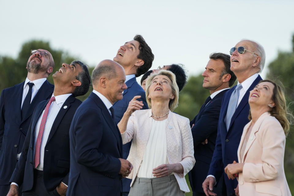 From right, Italian Prime Minister Giorgia Meloni, U.S. President Joe Biden, French President Emmanuel Macron, European Commission President Ursula von der Leyen, Japan's Prime Minister Fumio Kishida, Canada's Prime Minister Justin Trudeau, German Chancellor Olaf Scholz, Britain's Prime Minister Rishi Sunak and European Council President Charles Michel watch a skydiving demo during the G7 world leaders summit at Borgo Egnazia, Italy, Thursday, June 13, 2024. (AP Photo/Domenico Stinellis)