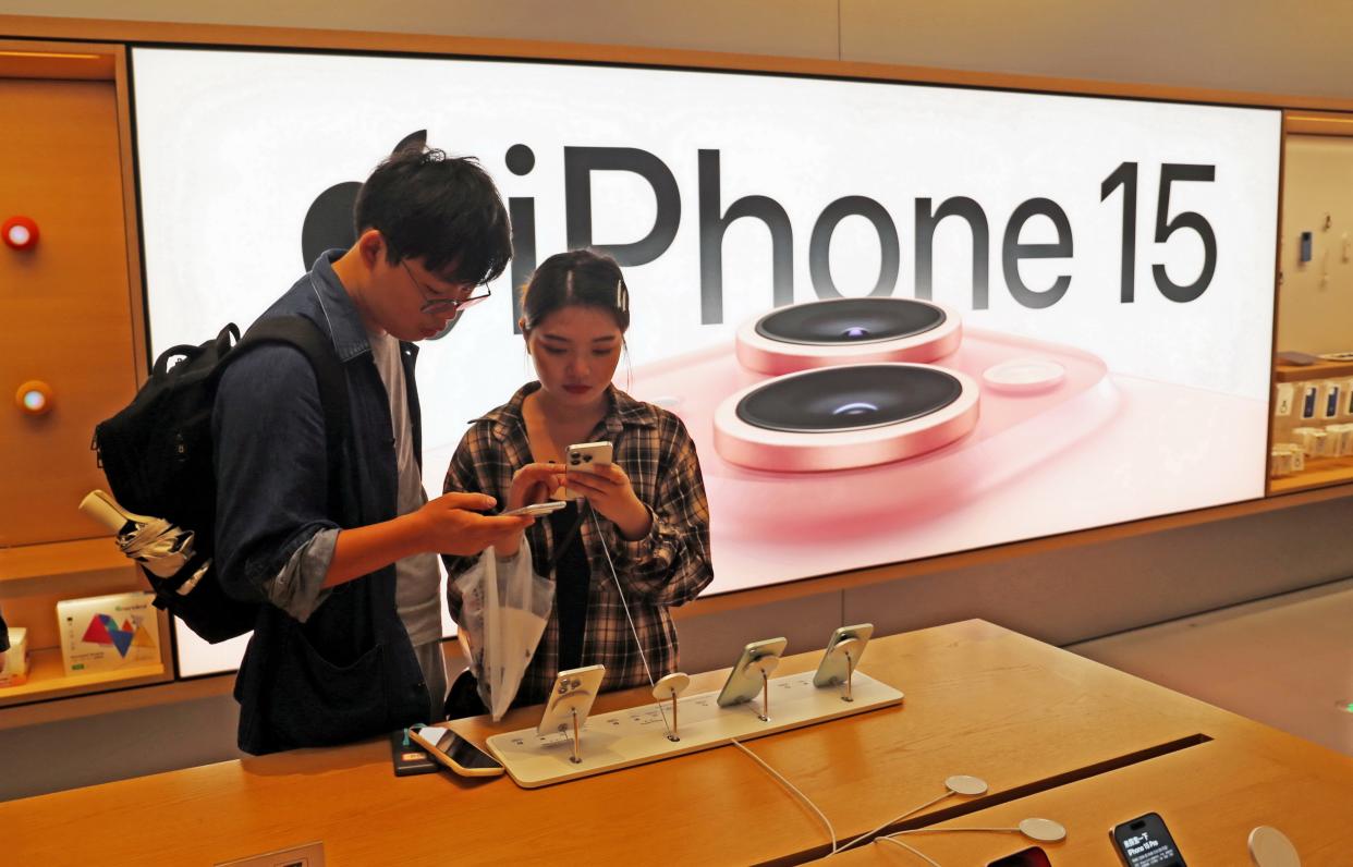 Customers trying out Apple's iPhone 15 at an Apple store in Shanghai, China.