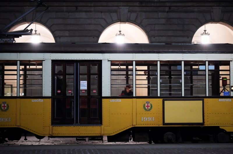 People wearing face masks are seen on a train as the spread of coronavirus disease (COVID-19) continues, in Milan