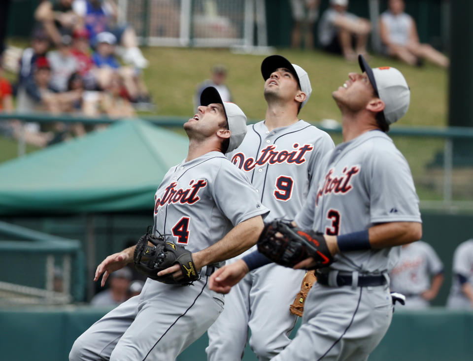 Detroit Tigers shortstop Stephen Lombardozzi (4), third baseman Nick Castellanos (9) and second baseman Ian Kinsler (3) all move in for a fly ball hit by Atlanta Braves' B.J. Upton in the first inning of a spring exhibition baseball game, Wednesday, Feb. 26, 2014, in Kissimmee, Fla. Upton was out on the play. (AP Photo/Alex Brandon)