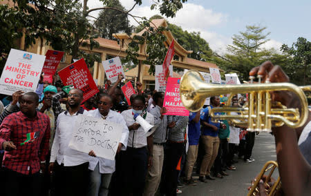 A brass band leads striking doctors chanting slogans outside the Court of Appeal as they wait for the release of jailed officials of the national doctors' union in their case to demand fulfilment of a 2013 agreement between their union and the government that would raise their pay and improve working conditions in Nairobi, Kenya, February 15, 2017. REUTERS/Thomas Mukoya