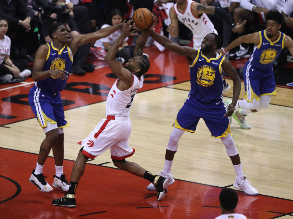 TORONTO, ON- MAY 30  -  Toronto Raptors forward Kawhi Leonard (2) is double teamed by Golden State Warriors center Kevon Looney (5) and Golden State Warriors forward Draymond Green (23) as the Toronto Raptors beat the Golden State Warriors in game One of the NBA Finals  in Toronto. May 30, 2019.        (Steve Russell/Toronto Star via Getty Images)