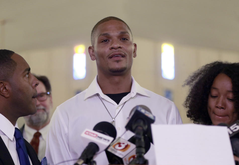 FILE - In this June 7, 2018, file photo, Robert Johnson, 35, speaks at New Beginnings Christian Church in Mesa, Ariz. Suburban Phoenix police officers shown on video beating an unarmed Johnson as he stood against a wall three months ago should not face criminal charges, outside police investigators said Monday, Aug. 27, 2018, about one of a series of recent incidents that drew questions about the agency's use of force. (AP Photo/Matt York, File)