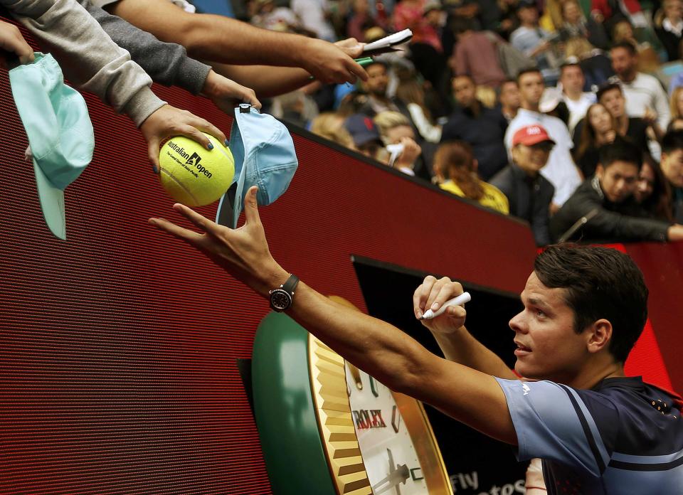 Canada's Milos Raonic signs autographs after winning his fourth round match against Switzerland's Stan Wawrinka at the Australian Open tennis tournament at Melbourne Park, Australia, January 25, 2016. REUTERS/Tyrone Siu