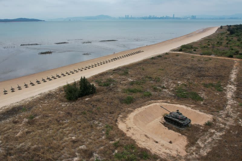 A retired military tank is seen on the beach with China in the background in Kinmen