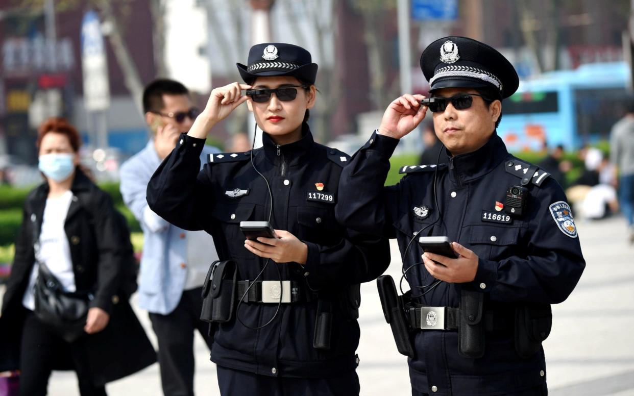 Police officers display their AI-powered smart glasses - REUTERS