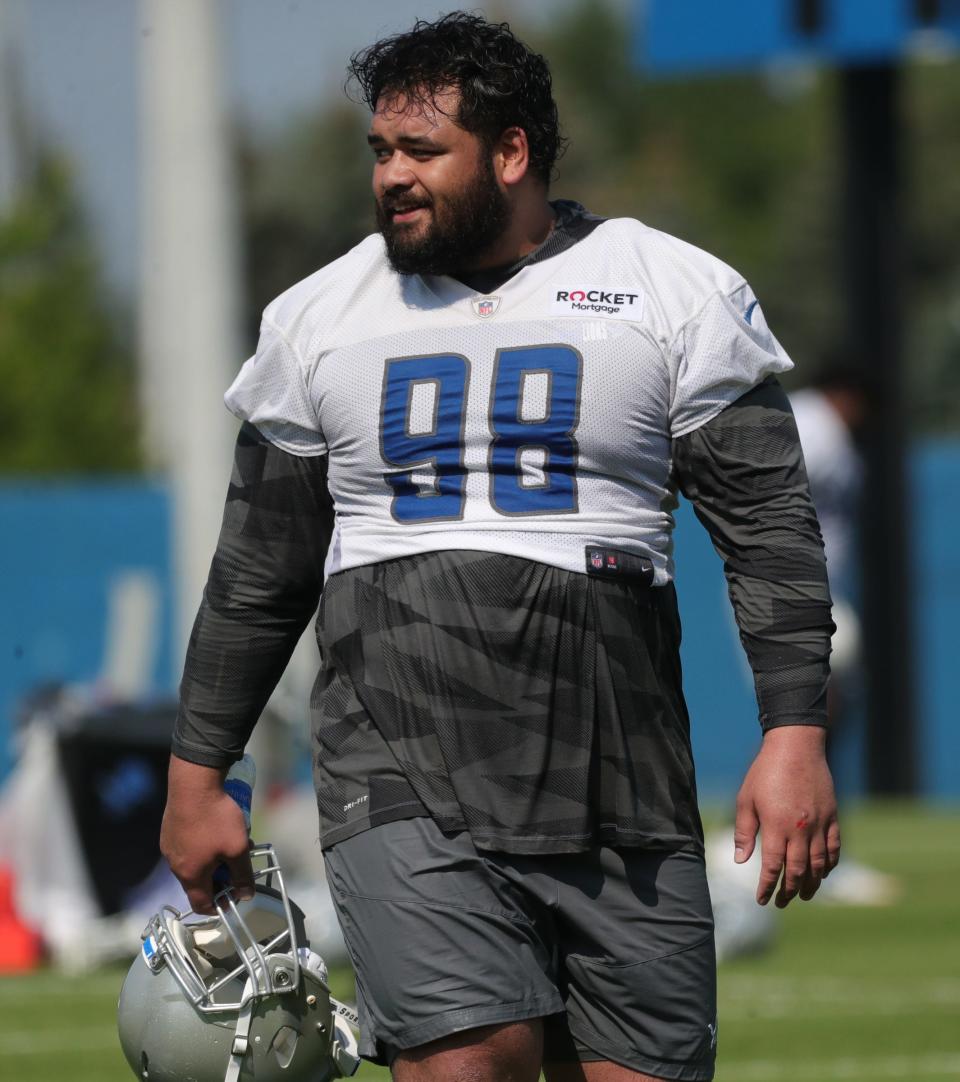 Detroit Lions nose tackle John Penisini walks off the field after  training camp at the Allen Park facility Wednesday, July 28, 2021. 