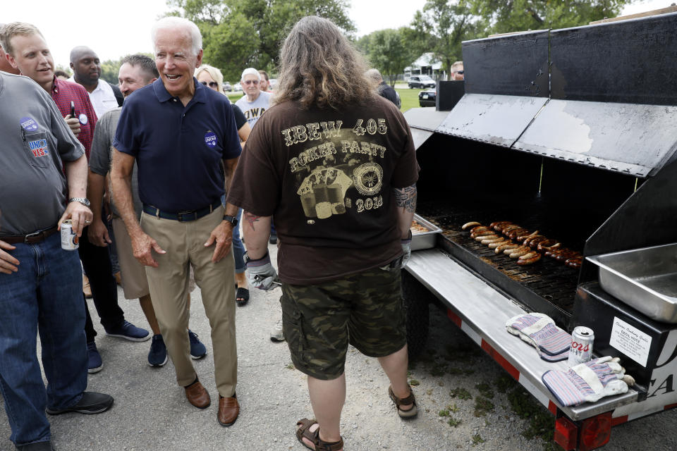 Democratic presidential candidate former Vice President Joe Biden talks with grill workers during the Hawkeye Area Labor Council Labor Day Picnic, Monday, Sept. 2, 2019, in Cedar Rapids, Iowa. (AP Photo/Charlie Neibergall)