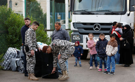 Lebanese general security members check luggage of Syrian refugees returning to Syria, in Beirut, Lebanon, December 6, 2018. Picture taken December 6, 2018. REUTERS/Jamal Saidi