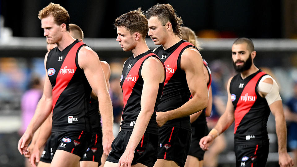 Essendon players look dejected after losing their round 16 AFL match to Geelong. (Photo by Bradley Kanaris/Getty Images)