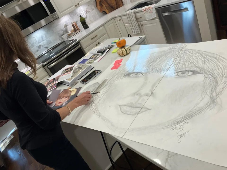 Jeanette Paras of Dublin, Ohio displays sketches of her Taylor Swift pumpkin in her kitchen.