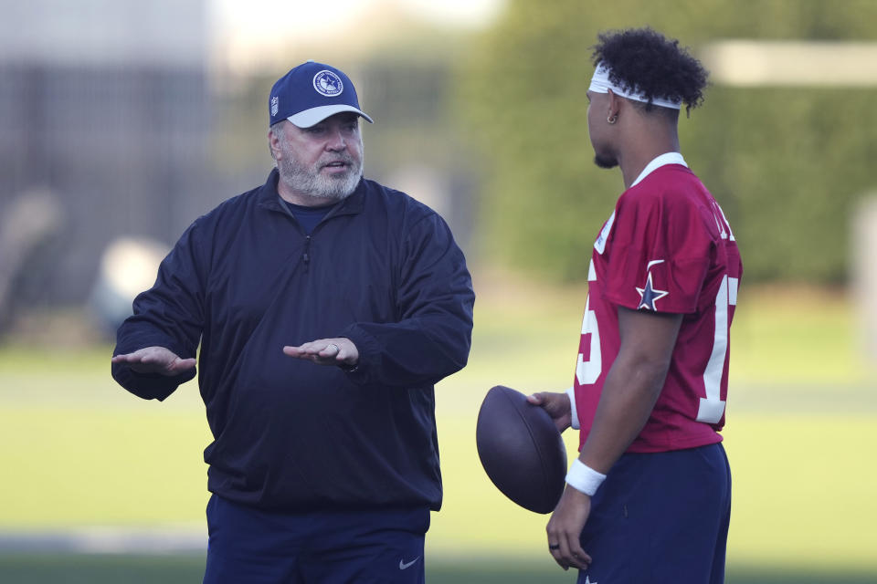 Dallas Cowboys head coach Mike McCarthy, left, talks with quarterback Trey Lance (15) during NFL football practice in Frisco, Texas, Wednesday, Aug. 30, 2023. (AP Photo/LM Otero)