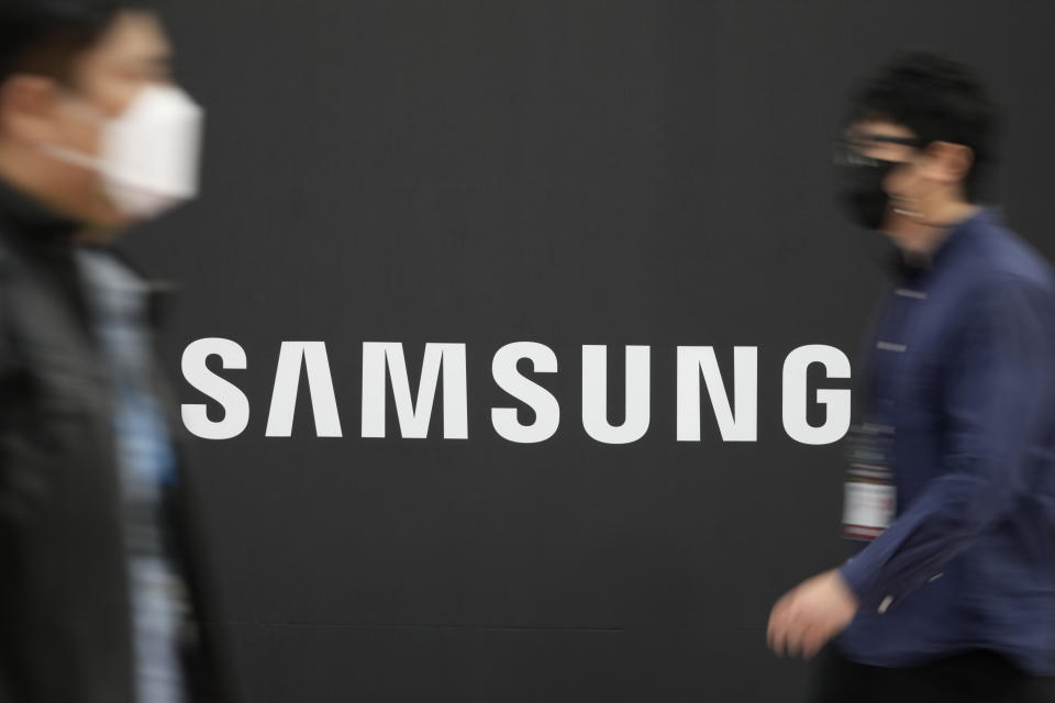 Visitors walk past the logo of Samsung Electronics at a semiconductor exhibition in Seoul, South Korea, Thursday, Oct. 28, 2021. Samsung Electronics Co. said Thursday its operating profit for the last quarter rose by more than 53% from the same period last year as it continued to thrive during the pandemic while relying on its dual strength in parts and finished products. (AP Photo/Lee Jin-man)