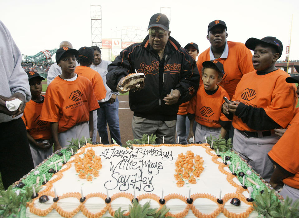 FILE - Willie Mays is surrounded by children from the Boys and Girls Club of San Francisco as he celebrates his birthday, before a baseball game between the San Francisco Giants and the Philadelphia Phillies in San Francisco, May 4, 2007. Mays, the electrifying “Say Hey Kid” whose singular combination of talent, drive and exuberance made him one of baseball’s greatest and most beloved players, has died. He was 93. Mays' family and the San Francisco Giants jointly announced Tuesday night, June 18, 2024, he had “passed away peacefully” Tuesday afternoon surrounded by loved ones. (AP Photo/Marcio Jose Sanchez. File)