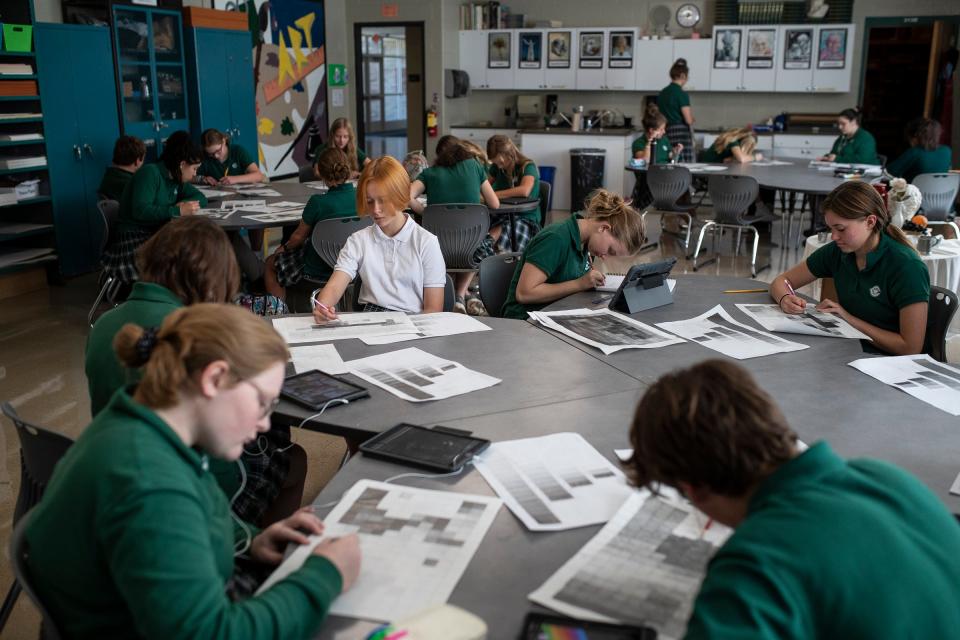 Sofiia Lytvyniuk, 12, center, works on a value identification project in Art 1 drawing class at the Grand Rapids West Catholic High School in Grand Rapids on Wednesday, Sept. 7, 2022.