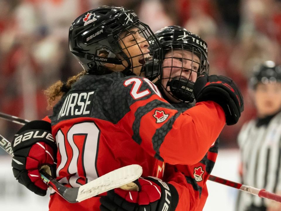 Canada forward Sarah Nurse, left, is congratulated by teammate Sarah Fillier after the game-winning goal during a 3-2 overtime victory against Sweden in Brampton, Ont., on Thursday. (Frank Gunn/The Canadian Press - image credit)