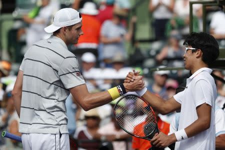 Mar 28, 2018; Key Biscayne, FL, USA; John Isner of the United States (L) shakes hands Hyeon Chung of Korea (R) after their match on day nine at the Miami Open at Tennis Center at Crandon Park. Isner won 6-1. 6-4. Mandatory Credit: Geoff Burke-USA TODAY Sports