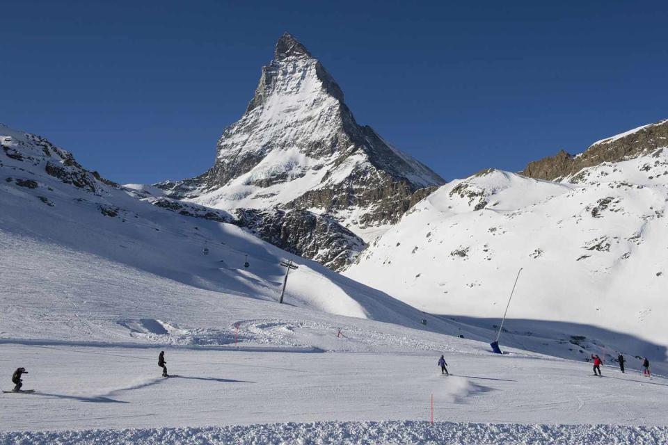 <p>Jean-Christophe Bott/Keystone via AP</p> Skiers ride down the slopes of the Zermatt ski resort with the Mount Matterhorn in the background, on Jan. 16, 2012, in Zermatt in the canton of Valais, Switzerland