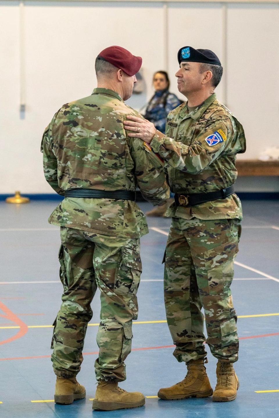 Maj. Gen. Gregory K. Anderson, right, commander of the 10th Mountain Division and "Task Force Mountain", and Maj. Gen. Pat Work, left, commander of the 82nd Airborne Division and "Task Force 82", shake hands during a Dec. 15, 2023, transfer of authority ceremony hosted by the U.S. Army’s V Corps, at Mihail Kogalniceanu Air Base, Romania.