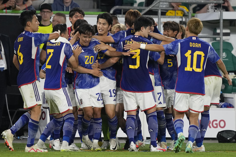 Japan players celebrate after Japan's Ao Tanaka scored his side's fourth goal during an international friendly soccer match between Germany and Japan in Wolfsburg, Germany, Saturday, Sept. 9, 2023. (AP Photo/Martin Meissner)