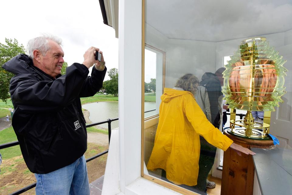 Bill Yuhasz of Port Clinton takes a photo of the Fresnel lens at the Port Clinton lighthouse.