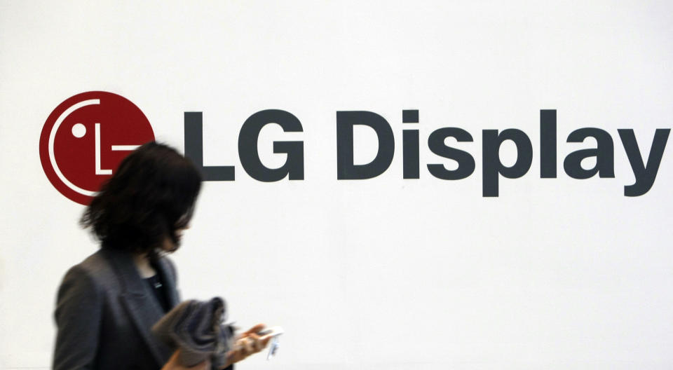 In this photo taken on Jan. 20, 2010, a woman walks past near the LG Display advertisement in Seoul, South Korea. LG Display Co., the world's second-largest maker of liquid crystal displays, Tuesday, April 24, 2012, reported its third straight quarterly loss due to feeble demand for TVs. (AP Photo/Lee Jin-man)