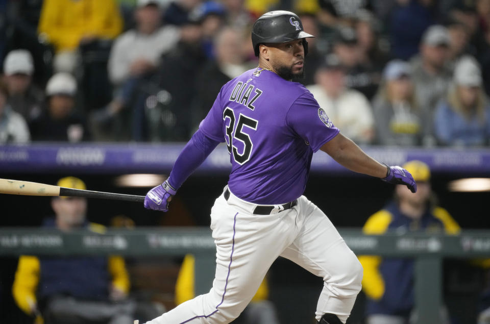 Colorado Rockies' Elias Diaz follows the flight of his RBI-single to drive in the go-ahead run off Milwaukee Brewers relief pitcher Peter Strzelecki in the eighth inning of a baseball game Tuesday, May 2, 2023, in Denver. (AP Photo/David Zalubowski)