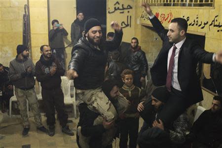 Free Syrian Army fighters celebrate during the wedding of one of their commanders in Aleppo February 7, 2014. REUTERS/Ammar Abdullah