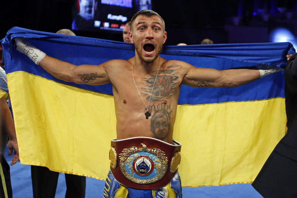 FILE - Vasiliy Lomachenko, of Ukraine, celebrates after defeating Guillermo Rigondeaux in a WBO junior lightweight title boxing match in New York, Dec. 9, 2017. Former heavyweight champions Vitali and Wladimir Klitschko are leading some of the resistance from the mayor's office in beleaguered Kyiv. Two-time Olympic champion Vasiliy Lomachenko has an assault rifle and a place in a defense force, and current heavyweight champion Aleksandr Usyk rushed back home to take up arms against the Russians. Ukraine's rich boxing community is determined to fight, this time with guns instead of their fists. (AP Photo/Adam Hunger, File)