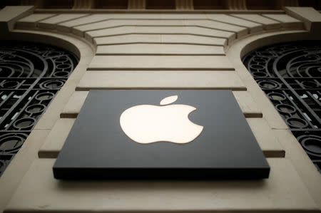 The logo of Apple company is seen outside an Apple store in Paris, France, April 10, 2019. REUTERS/Christian Hartmann/File Photo