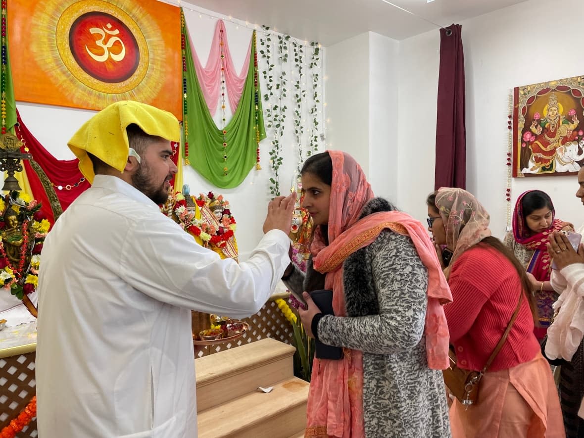 Moncton's Hindu temple opened its doors for the first time Monday. A large crowd turned out to pray, practise spiritual rituals and share food. (Alexandre Silberman/CBC - image credit)