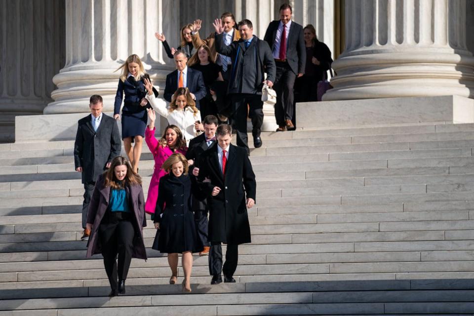 Lorie Smith, center in pink, walks out of the Supreme Court on Dec. 5, 2022, after the high court heard oral arguments in her case. <a href="https://www.gettyimages.com/detail/news-photo/lorie-smith-a-christian-graphic-artist-and-website-designer-news-photo/1245399590?adppopup=true" rel="nofollow noopener" target="_blank" data-ylk="slk:Kent Nishimura/Los Angeles Times via Getty Images;elm:context_link;itc:0;sec:content-canvas" class="link ">Kent Nishimura/Los Angeles Times via Getty Images</a>