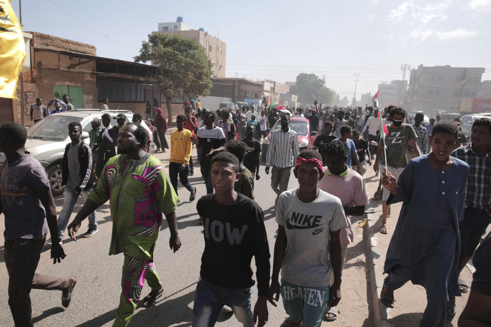 People march during a protest to denounce the October military coup, in Khartoum, Sudan, Saturday, Dec. 25, 2021. Sudanese security forces fired tear gas to disperse protesters as thousands rallied since earlier in the day, even as authorities tightened security across Khartoum, deploying troops and closing all bridges over the Nile River linking the capital with its twin city of Omdurman and the district of Bahri, the state-run SUNA news agency reported.(AP Photo/Marwan Ali)