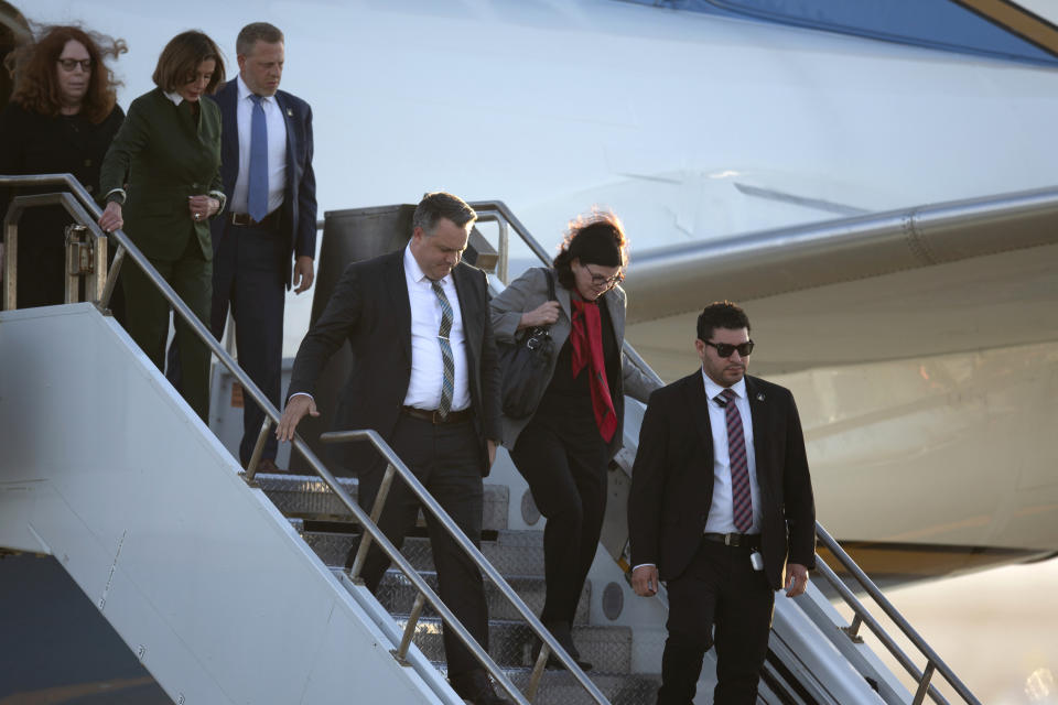 Katherine Feinstein, second from right, arrives at San Francisco International Airport on a flight carrying the body of her mother, U.S. Sen. Dianne Feinstein, D-Calif., Saturday, Sept. 30, 2023, in San Francisco. U.S. Rep. Nancy Pelosi, D-Calif., is at left. (AP Photo/D. Ross Cameron)
