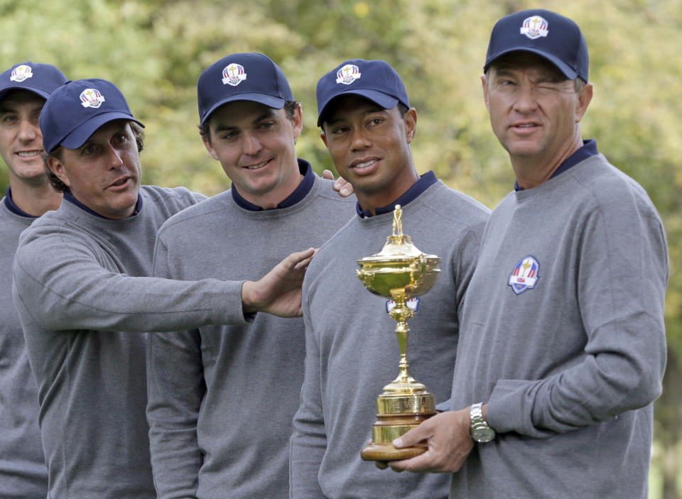 FILE - In this Sept. 25, 2012, file photo, from left, USA's Phil Mickelson, Keegan Bradley, Tiger Woods and captain Davis Love III have some fun as they pose for a picture with the trophy at the Ryder Cup golf tournament at Medinah Country Club in Medinah, Ill. Bradley was selected as U.S. Ryder Cup captain for 2025, The PGA of America announced Monday, July 8, 2024. (AP Photo/Chris Carlson, File)