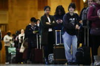 Travelers wait in line to board an Amtrak train ahead of the Thanksgiving Day holiday at 30th Street Station in Philadelphia, Wednesday, Nov. 22, 2023. (AP Photo/Matt Rourke)