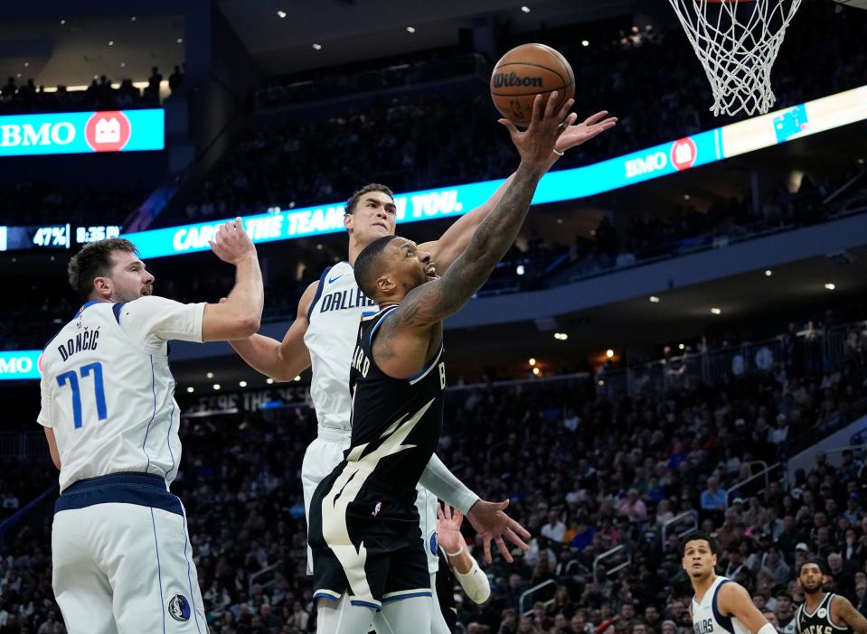 Milwaukee Bucks guard Damian Lillard (0) scores with a lay up during the second half of the game against the Dallas Mavericks on Saturday November 18, 2023 at the Fiserv Forum in Milwaukee, Wis.