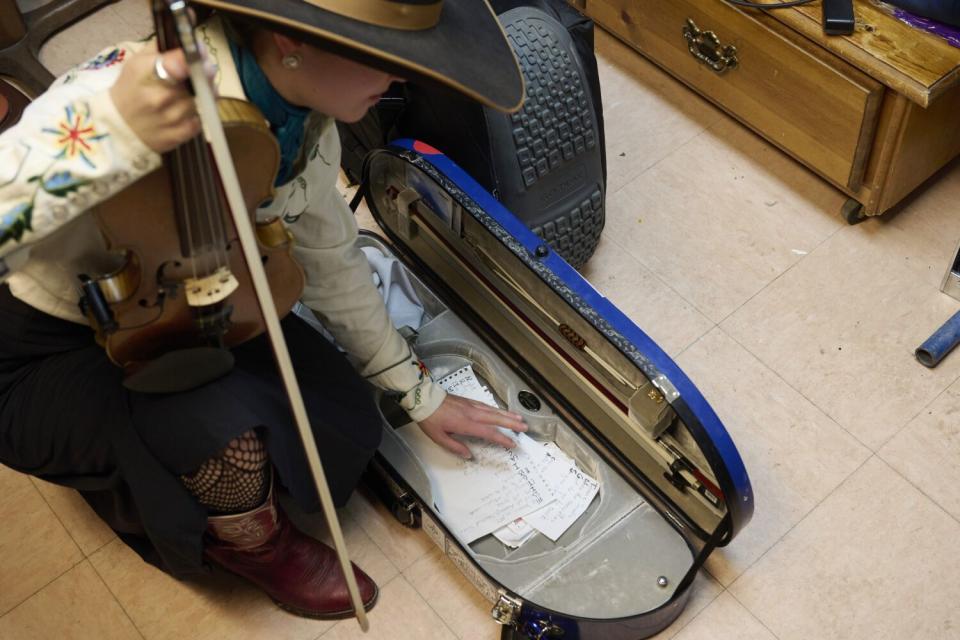 Brigid Reedy packs up after a performance during the National Cowboy Poetry Gathering.