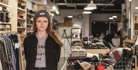 Casually dressed woman entrepreneur in her clothing store that matches her style.