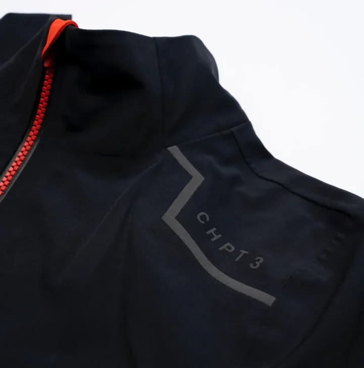 The jacket features red detailing and reflective logos.