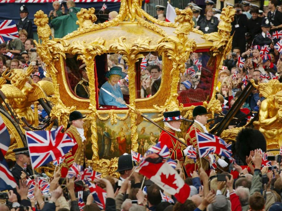 Queen Elizabeth and Prince Philip ride in the Golden State Carriage at the head of a parade from Buckingham Palace to St Paul's Cathedral celebrating the Queen's Golden Jubilee (Getty Images)