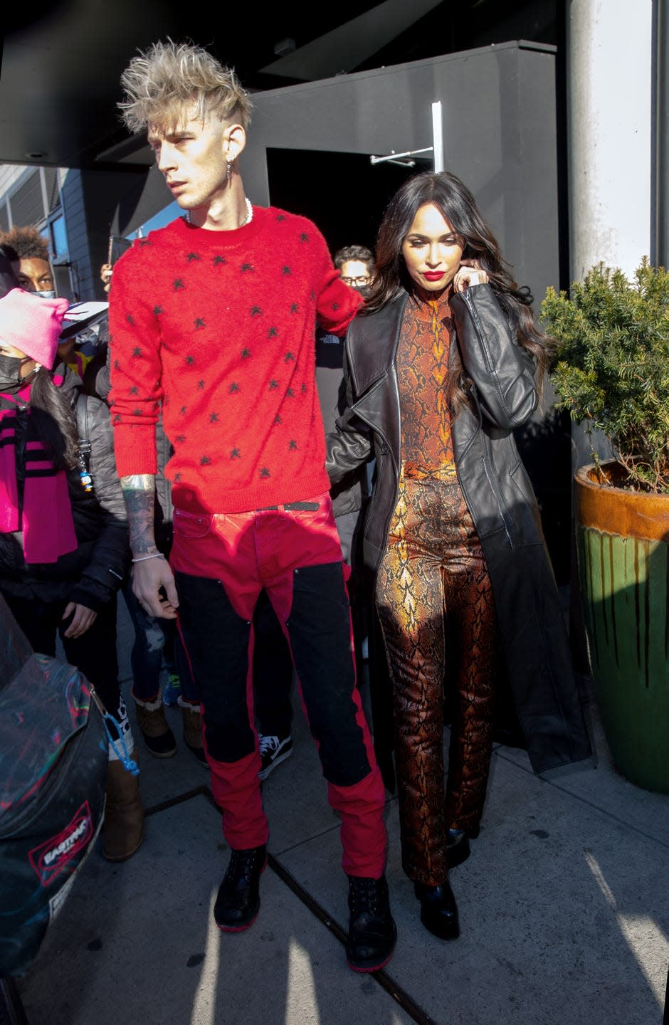 <p>Fox opted for a bold red snakeprint pair of trousers and matching high neck top ahead of her beau's TV appearance. She styled the look with a black leather jacket and a red lip. </p>