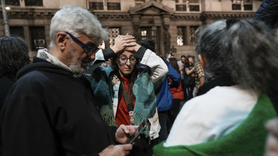 An anti-government protester reacts outside Congress after learning that the Senate passed a bill of reforms proposed by President Javier Milei in Buenos Aires, Argentina, Wednesday, June 12, 2024. The bill must now be debated article-by-article before being sent to the Lower House. (AP Photo/Rodrigo Abd)