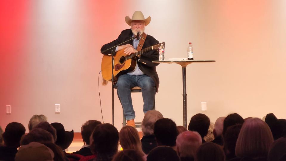 Renowned "Cowboy Poet" Red Steagall weaves one of his tales of the cowboy way Thursday to the audience at West Texas A&M's Legacy Hall.