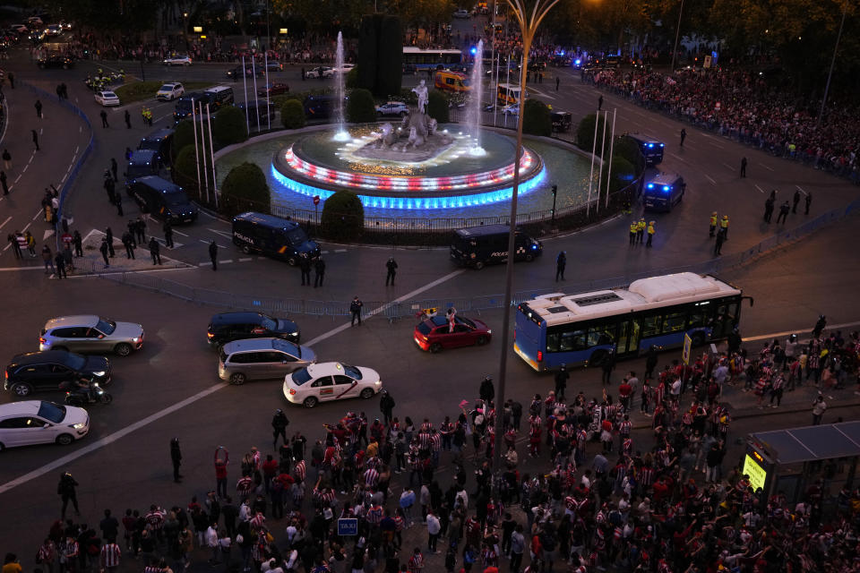 The Neptuno fountain is illuminated with the colours of Atletico Madrid as their supporters celebrate their team's Spanish La Liga title in Madrid, Saturday, May 22, 2021. Atletico clinches its 11th Spanish La Liga title. (AP Photo/Paul White)