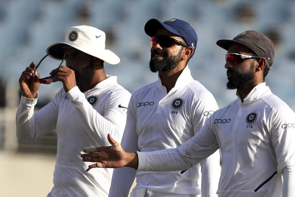 India's captain Virat Kohli, center, leaves the field with teammates at the end of day three of the second Test cricket match at Sabina Park cricket ground in Kingston, Jamaica Sunday, Sept. 1, 2019. (AP Photo/Ricardo Mazalan)